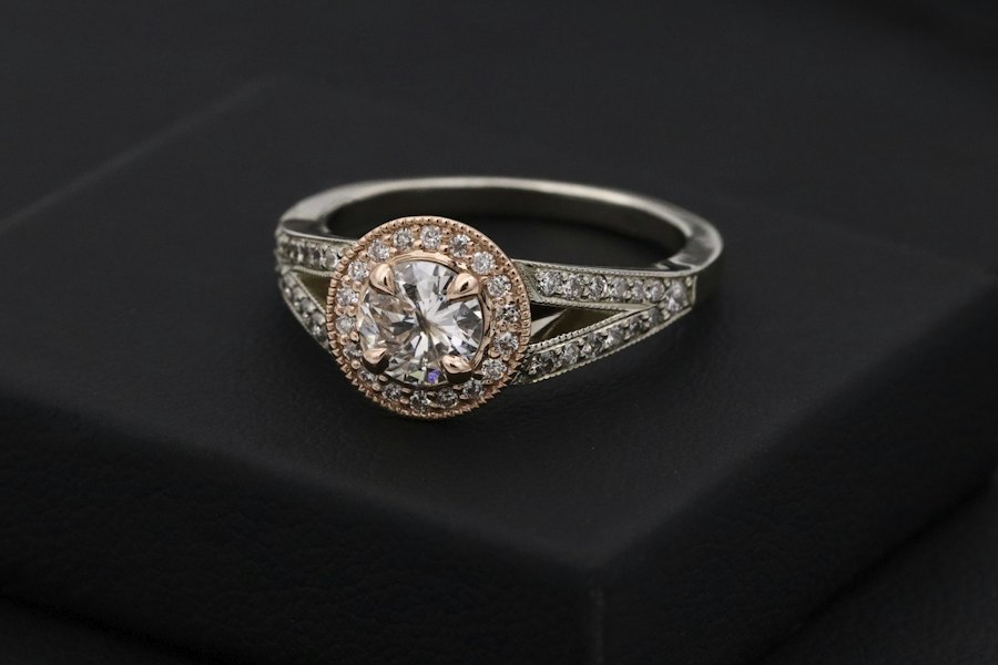 Bench setter placing small round brilliant moissanite melee into a pave setting